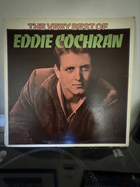 A “The Very Best of Eddie Cochran” LP resting on a turntable