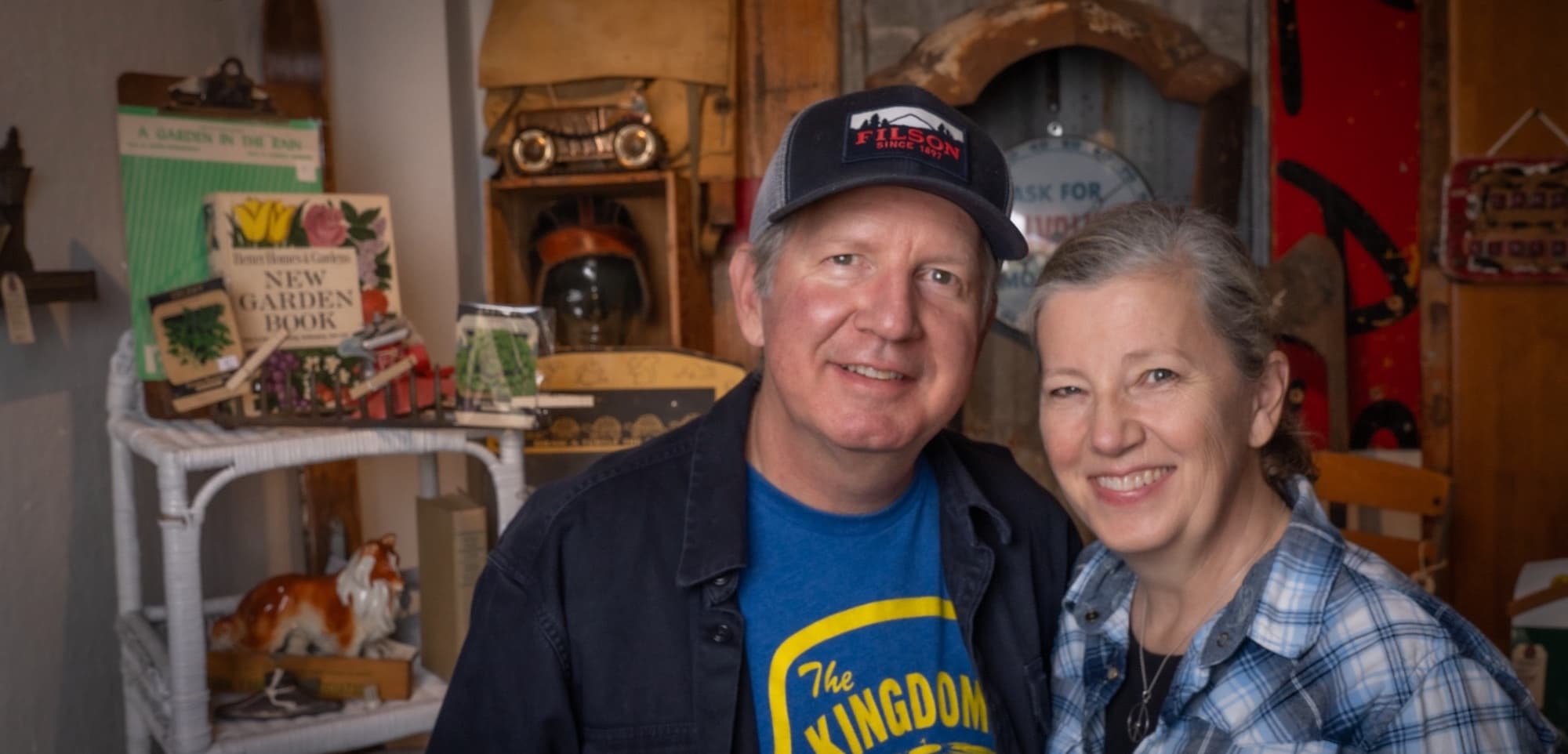 Christine and Logan Harris among the layered vintage displays inside their Edmonds bungalow shop